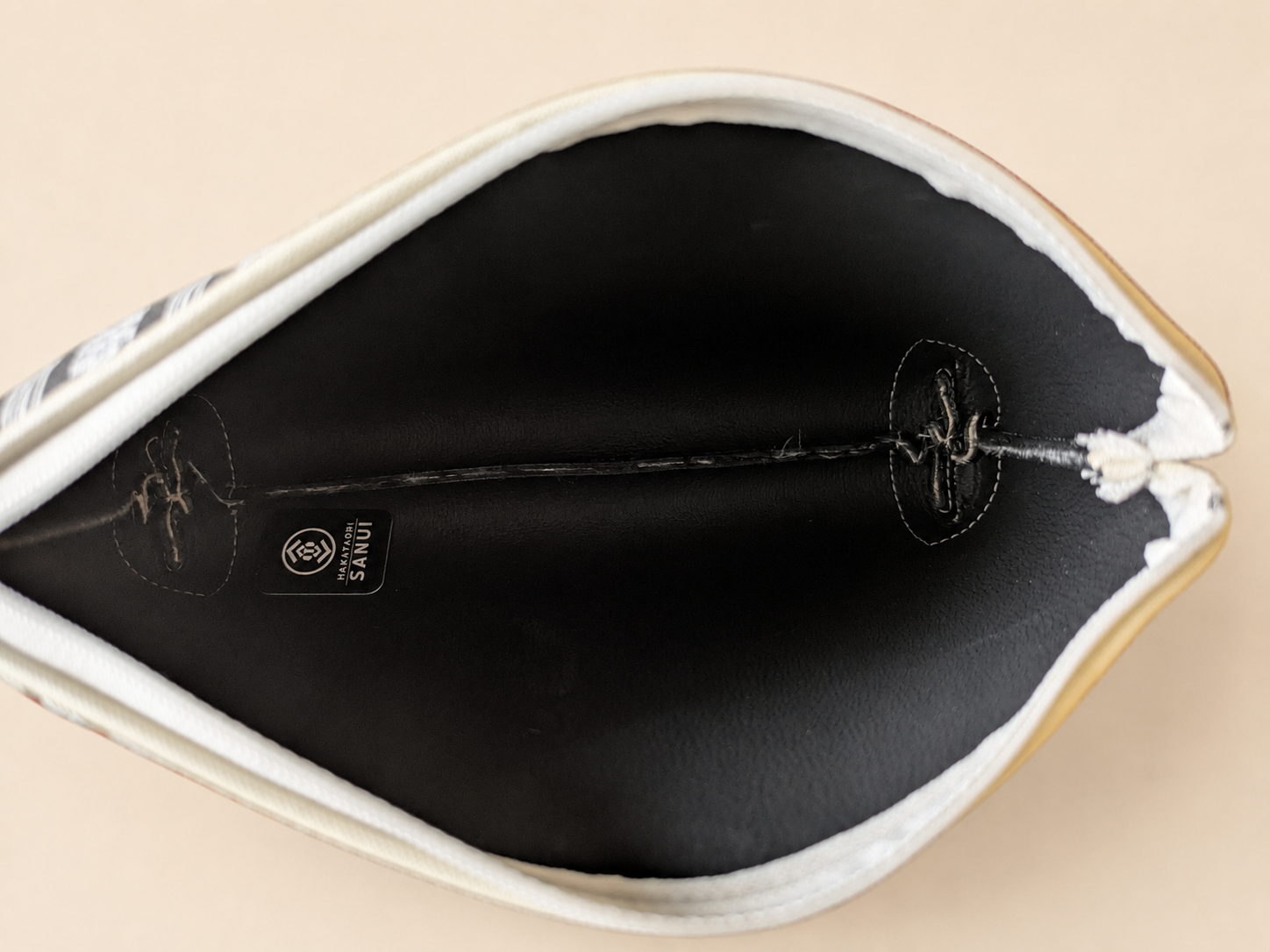Gray Hakata-ori Kenjo pastel large pouch opened to show the interior