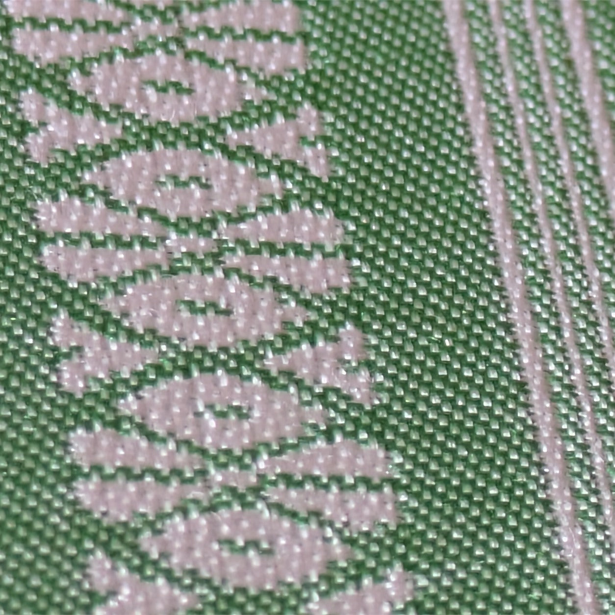 Close-up of the green Kenjo-pattern Hakata-ori silk weave