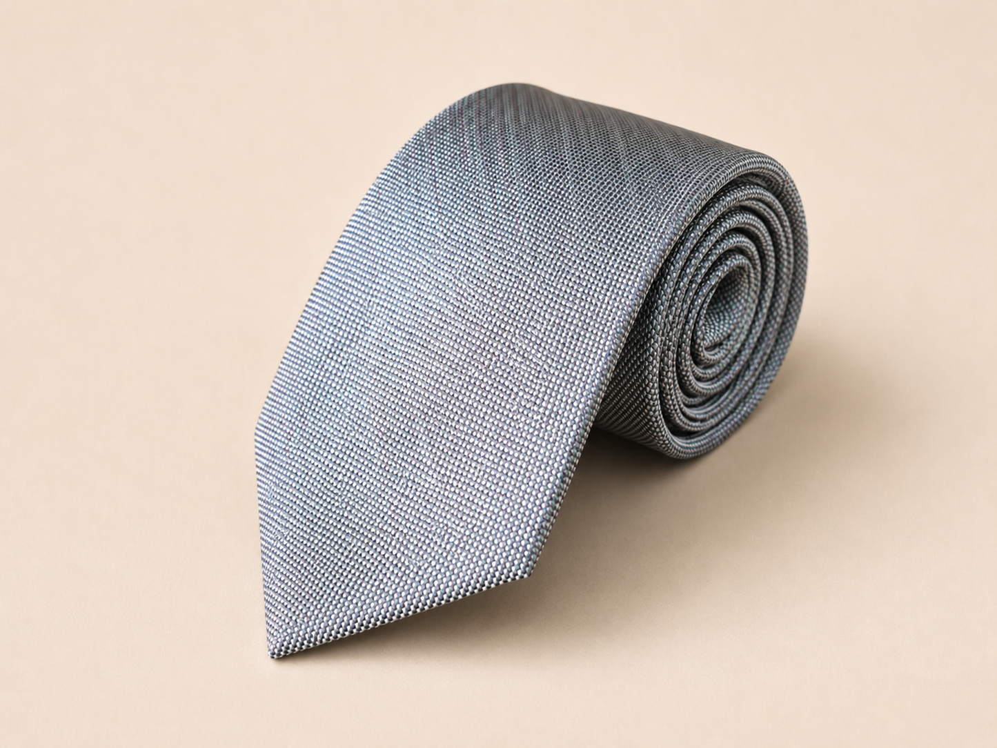 Sanui Hakata-ori mud-dyed silk necktie in silver, rolled view