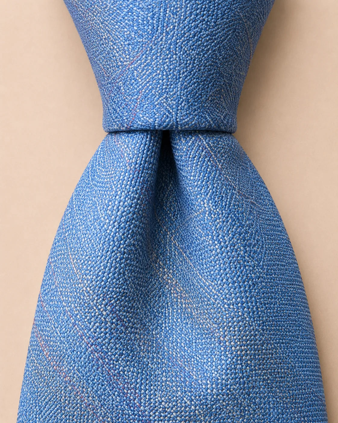 Blue Hakata-ori silk tie knot showing crisp woven texture