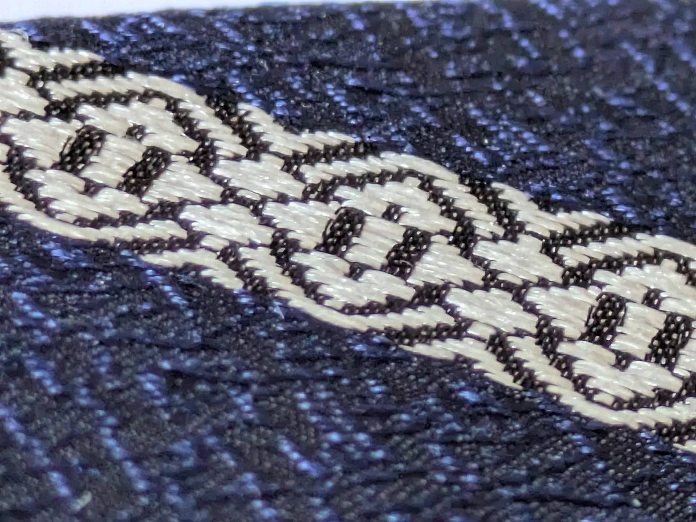Macro close-up of dense Hakata-ori warp threads and Kenjo stripe texture