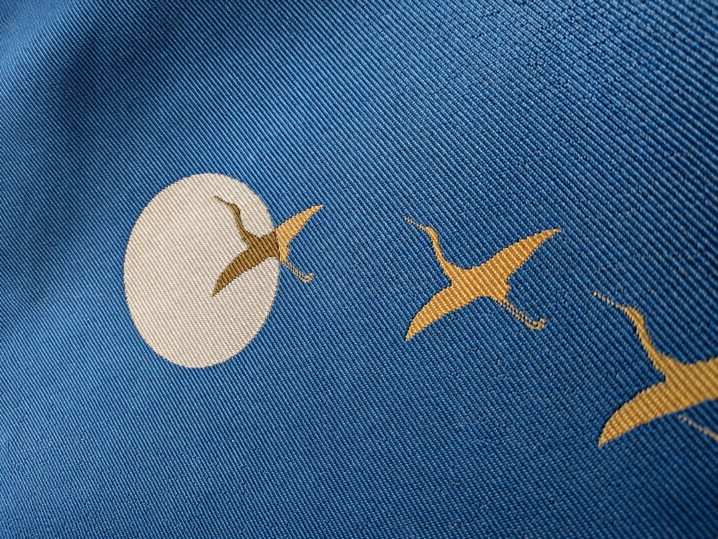Blue Hakata-ori silk with a woven crane pattern